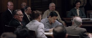 Movie still from “Capote” (2005), directed by Bennett Miller – A group of people sitting around a table; Medium shot, Over the shoulder angle
