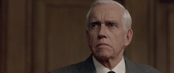 Movie still from “Capote” (2005), directed by Bennett Miller – An older man wearing a suit and tie; Close Up shot, Low angle