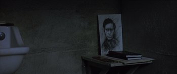 Movie still from “Capote” (2005), directed by Bennett Miller – A black and white drawing of a man on top of a table; Close Up shot, High angle