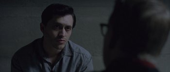Movie still from “Capote” (2005), directed by Bennett Miller – A man sitting in front of another man in front of a brick wall; Close Up shot, Over the shoulder angle