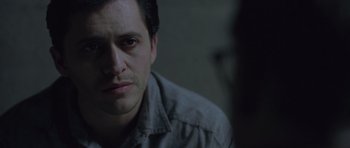 Movie still from “Capote” (2005), directed by Bennett Miller – A person wearing a gray shirt; Close Up shot, Over the shoulder angle