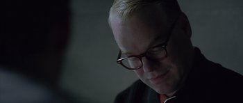 Movie still from “Capote” (2005), directed by Bennett Miller – A person wearing glasses; Close Up shot, Over the shoulder angle
