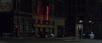 Movie still from “Capote” (2005), directed by Bennett Miller – A car parked on the side of the street at night; Extreme Wide shot, High angle