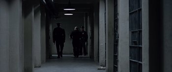 Movie still from “Capote” (2005), directed by Bennett Miller – A group of people walking down a hallway; Wide shot, High angle