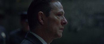 Movie still from “Capote” (2005), directed by Bennett Miller – A person wearing a suit and tie; Close Up shot, Low angle