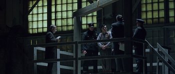 Movie still from “Capote” (2005), directed by Bennett Miller – A group of people standing around a building; Wide shot, Low angle