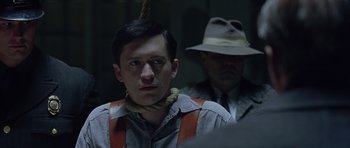 Movie still from “Capote” (2005), directed by Bennett Miller – A man with a hat and a rope around his neck; Close Up shot, Over the shoulder angle