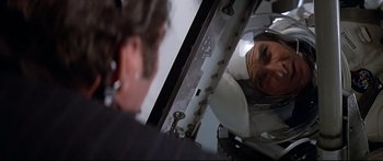 Movie still from “Capricorn One” (1977), directed by Peter Hyams – A man looking at himself in a mirror; Close Up shot, Over the shoulder angle