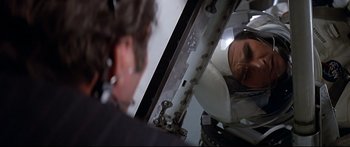 Movie still from “Capricorn One” (1977), directed by Peter Hyams – A man looking into a mirror in a room; Close Up shot, Over the shoulder angle