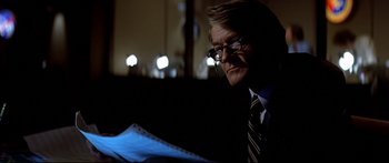 Movie still from “Capricorn One” (1977), directed by Peter Hyams – An older man in a suit and tie looking at papers; Close Up shot, Low angle