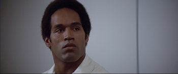 Movie still from “Capricorn One” (1977), directed by Peter Hyams – A person wearing a white shirt; Close Up shot, Low angle