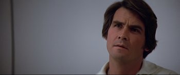 Movie still from “Capricorn One” (1977), directed by Peter Hyams – A person looking at the camera; Close Up shot, Low angle