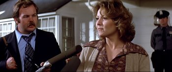 Movie still from “Capricorn One” (1977), directed by Peter Hyams – A person holding a microphone; Close Up shot, Over the shoulder angle