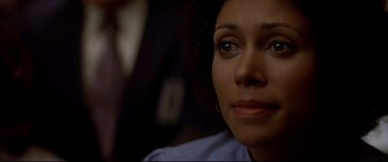 Movie still from “Capricorn One” (1977), directed by Peter Hyams – A woman's face in a dark room; Close Up shot, Over the shoulder angle