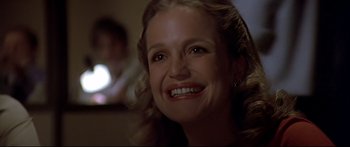 Movie still from “Capricorn One” (1977), directed by Peter Hyams – A person smiling; Close Up shot, Low angle