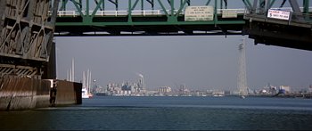 Movie still from “Capricorn One” (1977), directed by Peter Hyams – A view of a city from the water; Extreme Wide shot, Low angle