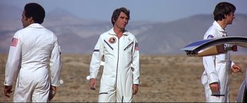 Movie still from “Capricorn One” (1977), directed by Peter Hyams – A man in a spacesuit standing in the desert; Medium shot, Low angle