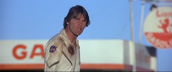 Movie still from “Capricorn One” (1977), directed by Peter Hyams – A person wearing a suit and tie; Close Up shot, Low angle