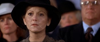 Movie still from “Capricorn One” (1977), directed by Peter Hyams – A person wearing a black hat; Close Up shot, Over the shoulder angle