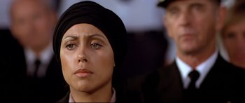 Movie still from “Capricorn One” (1977), directed by Peter Hyams – A person wearing a head covering; Close Up shot, Over the shoulder angle