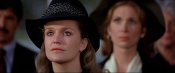 Movie still from “Capricorn One” (1977), directed by Peter Hyams – A woman wearing a black hat and a woman wearing a white shirt; Close Up shot, Low angle