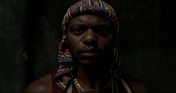 Movie still from “Carandiru” (2003), directed by Hector Babenco – A person wearing a hat; Close Up shot, Low angle