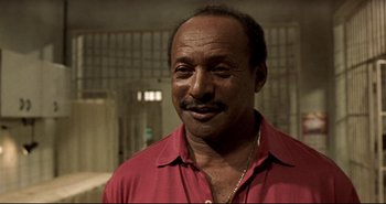 Movie still from “Carandiru” (2003), directed by Hector Babenco – A person wearing a red shirt; Close Up shot, Low angle