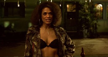 Movie still from “Carandiru” (2003), directed by Hector Babenco – A woman in a black bra and a leopard print jacket; Close Up shot, Low angle