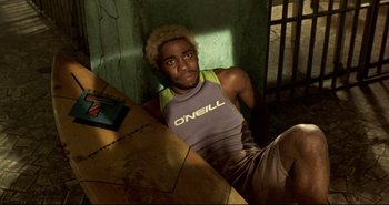 Movie still from “Carandiru” (2003), directed by Hector Babenco – A man sitting at a table in a room; Medium shot, High angle