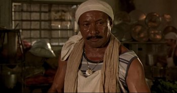 Movie still from “Carandiru” (2003), directed by Hector Babenco – A man wearing a white turban and a white shirt; Close Up shot, Low angle