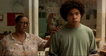 Movie still from “Carandiru” (2003), directed by Hector Babenco – A man with his arm around another man; Close Up shot, Over the shoulder angle