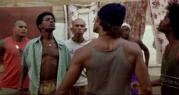 Movie still from “Carandiru” (2003), directed by Hector Babenco – A group of young men standing next to each other; Medium shot, Low angle