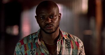 Movie still from “Carandiru” (2003), directed by Hector Babenco – A person wearing a colorful shirt; Close Up shot, Low angle