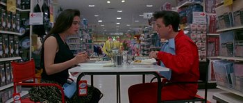 A man and a woman sitting at a table eating food