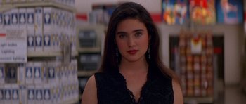 A woman with long dark hair wearing a black dress