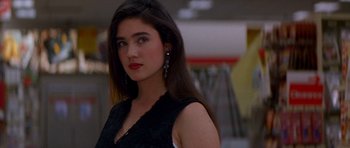 A beautiful young lady with long dark brown hair wearing a black dress