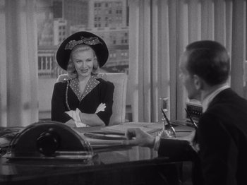 Movie still from “Carefree” (1938), directed by Mark Sandrich – An old photo of a man and a woman sitting at a table; Medium shot, Over the shoulder angle