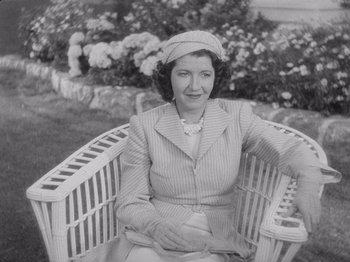 Movie still from “Carefree” (1938), directed by Mark Sandrich – An old photo of a woman sitting in a chair; Medium shot, High angle