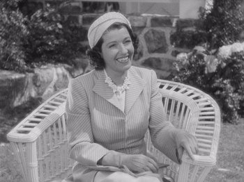 Movie still from “Carefree” (1938), directed by Mark Sandrich – An old photo of a woman sitting in a chair; Medium shot, High angle