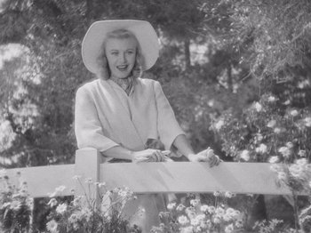 Movie still from “Carefree” (1938), directed by Mark Sandrich – A black and white photo of a woman wearing a hat; Medium shot, Low angle