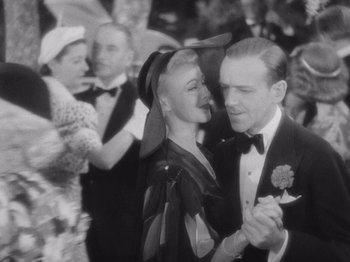 Movie still from “Carefree” (1938), directed by Mark Sandrich – A man and a woman are dancing in a crowd; Medium shot, High angle