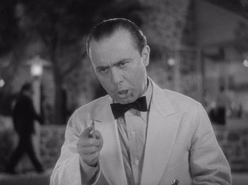 Movie still from “Carefree” (1938), directed by Mark Sandrich – An old photo of a man smoking a cigarette; Close Up shot, Low angle