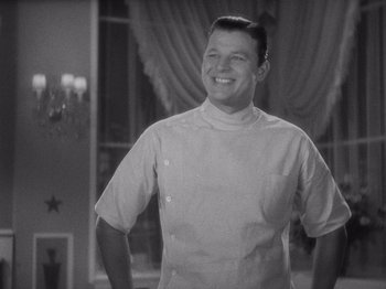 Movie still from “Carefree” (1938), directed by Mark Sandrich – A black and white photo of a man in a chef's outfit; Medium shot, Low angle