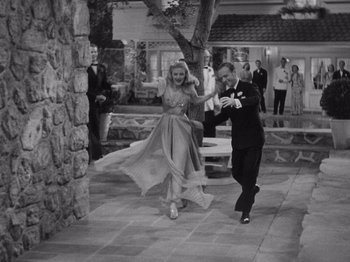 Movie still from “Carefree” (1938), directed by Mark Sandrich – A man and a woman dancing in formal wear; Wide shot, High angle
