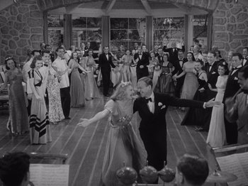 Movie still from “Carefree” (1938), directed by Mark Sandrich – A black - and - white photo of people in formal wear dancing; Wide shot, High angle