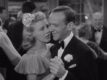 Movie still from “Carefree” (1938), directed by Mark Sandrich – A man and a woman dancing together in a black and white photo; Close Up shot, Low angle