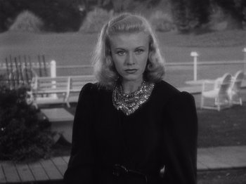 Movie still from “Carefree” (1938), directed by Mark Sandrich – A black and white photo of a woman in a black dress; Close Up shot, Low angle