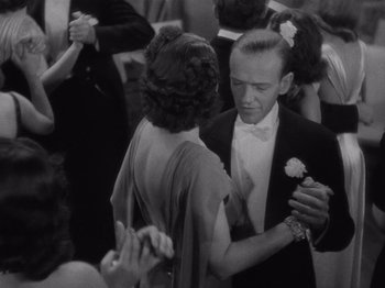 Movie still from “Carefree” (1938), directed by Mark Sandrich – A man and a woman dancing at a formal event; Medium shot, High angle