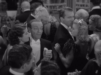 Movie still from “Carefree” (1938), directed by Mark Sandrich – A black and white photo of people at an event; Medium shot, High angle