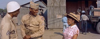 Movie still from “Carmen Jones” (1954), directed by Otto Preminger – A man and a woman in uniform talking to each other; Medium shot, Low angle